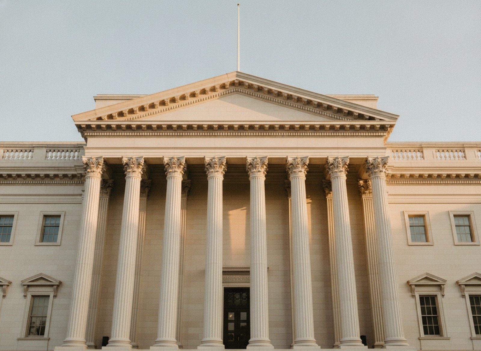 Classical government building facade with tall columns in warm morning light